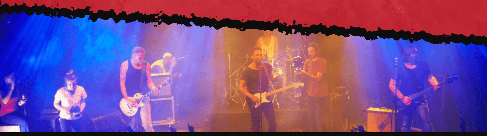 Live band performing on stage with colorful lights