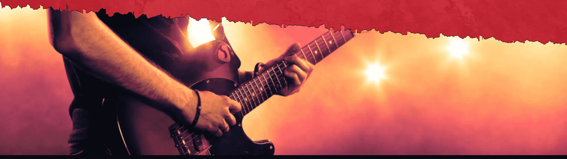 Close-up of hands playing electric guitar